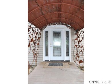 Exterior Front. New front door covered by copper l