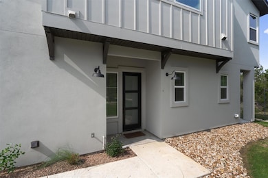 Doorway to property featuring stucco siding
