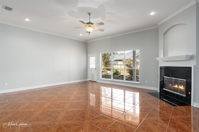 Unfurnished living room featuring ornamental molding, a high end fireplace, recessed lighting, and a ceiling fan