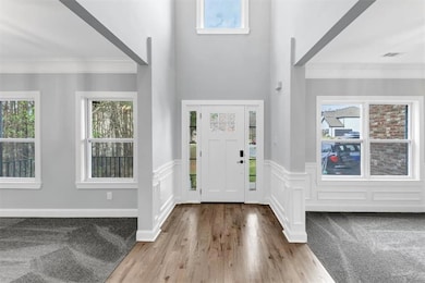Entrance foyer with wainscoting, a wealth of natur