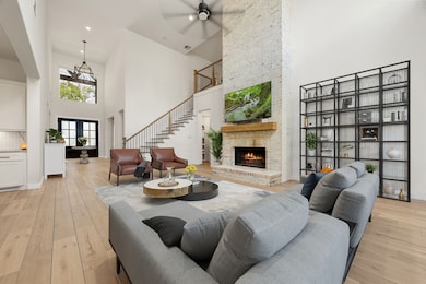 A soaring two-story great room makes a bold first