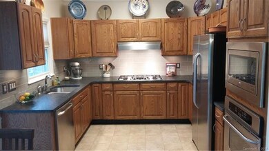 Well appointed kitchen with granite and stainless 