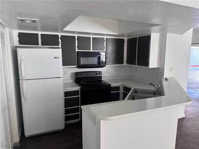 Kitchen featuring visible vents, light countertops