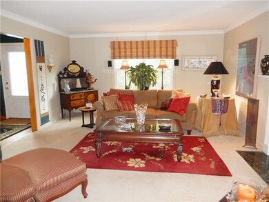Huge bright living room with fireplace that leads 