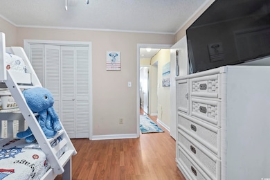 Bedroom featuring a closet, ornamental molding, a 