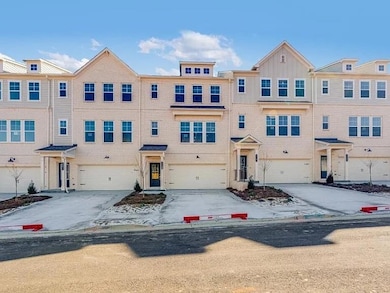 View of front of home featuring concrete driveway and a garage