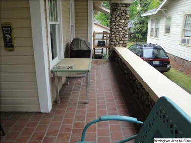 Wrap around porch with steps to the driveway.
