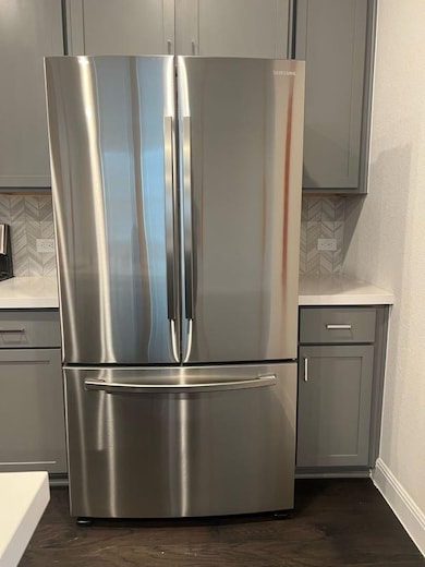 Detailed view of freestanding refrigerator, gray 