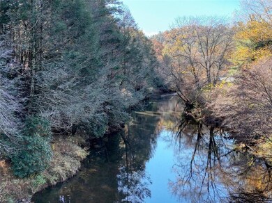 Water view featuring a heavily wooded area