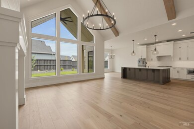 Unfurnished living room featuring a chandelier, light wood-type flooring, beamed ceiling, recessed lighting, and high vaulted ceiling