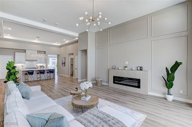 Living room with a chandelier, light wood-type flo