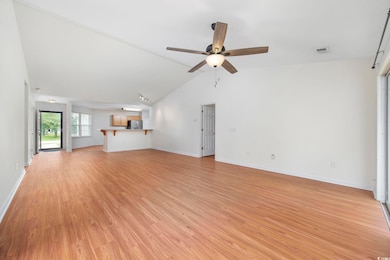 Unfurnished living room featuring ceiling fan, lig