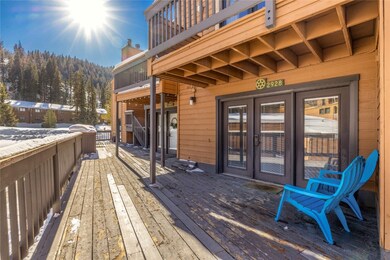 Snow covered deck featuring french doors
