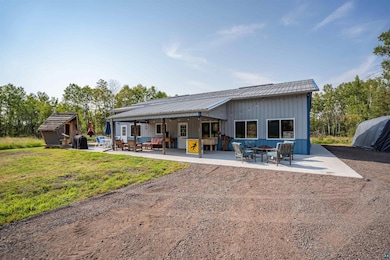 Rear view of property featuring a yard and a patio