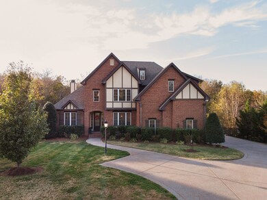 Gorgeous tudor home, winding sidewalk, side entrance to your 3 car garage, guest parking, gas lantern, mature landscaping, quiet side street, aggregate driveway....