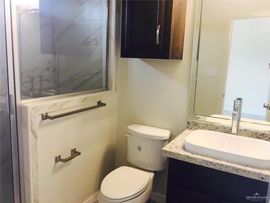 Bathroom featuring vanity and a shower