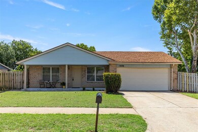 Single story home featuring a garage and a front y