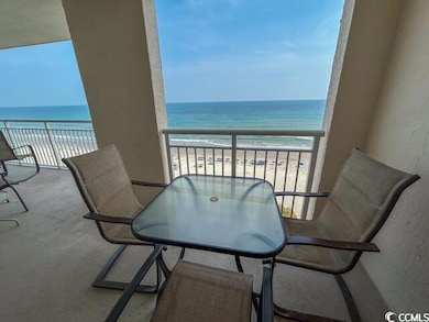 Balcony featuring a view of the beach and a water view