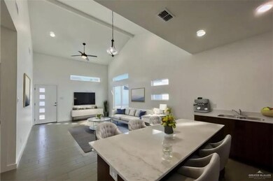 Dining area featuring high vaulted ceiling, visible vents, a ceiling fan, and wood finished floors