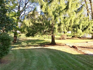 The rear yard is also filled with mature landscapi
