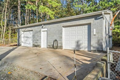 Oversized two car garage with tractor lean-to off the back