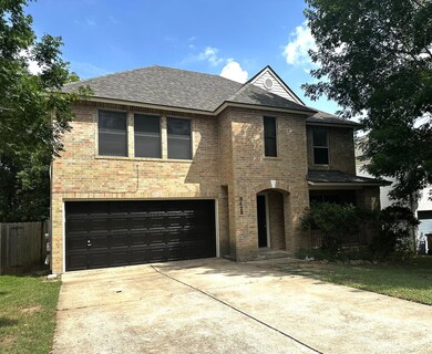 View of front of home featuring brick siding, dri