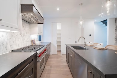 Kitchen with sink, hanging light fixtures, high en