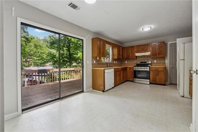 Kitchen with white appliances, under cabinet range