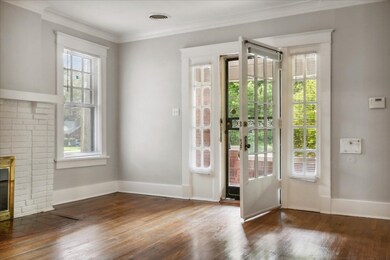 Doorway to outside featuring a brick fireplace, or