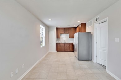 Kitchen with freestanding refrigerator, backsplas