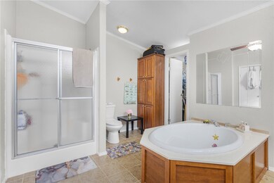 Full bath with a shower stall, ornamental molding,