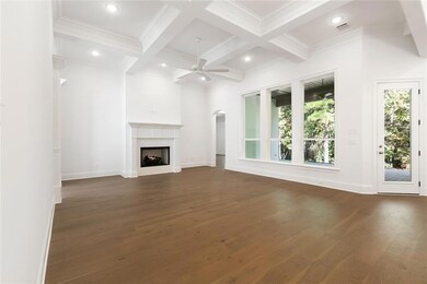 Living room has 12' coffered ceiling, custom crown