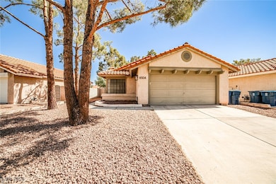 Mediterranean / spanish home featuring stucco siding, a tiled roof, driveway, and a garage