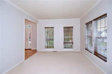 The living room is adorned with large windows and 