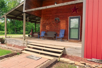 Wooden terrace featuring view of wooded area