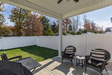 Fenced backyard with a patio and a ceiling fan