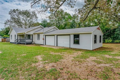 View of front of home featuring a shingled roof and a front lawn