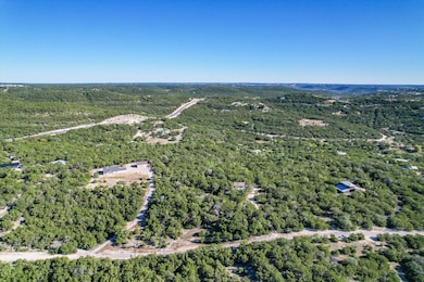 Aerial overview of property's location featuring a heavily wooded area
