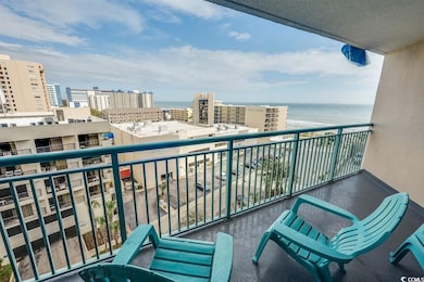 Balcony featuring a water view and a city view
