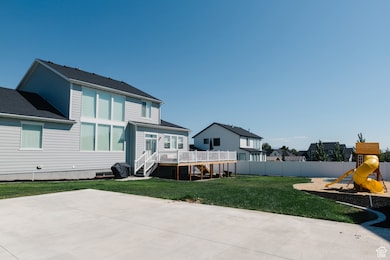 Rear view of property with a deck, stairway, a playground, and a residential view