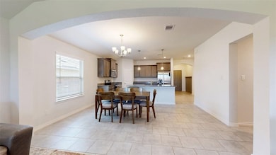 Dining space with a chandelier, arched walkways, l