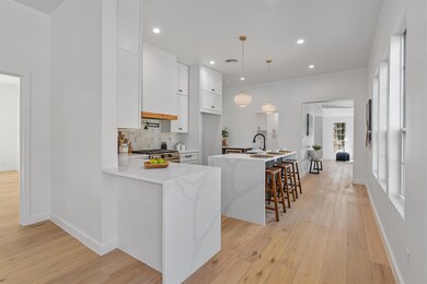 Kitchen with light wood-style flooring, stainless