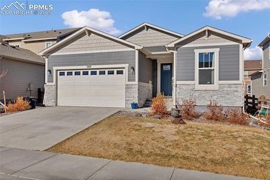 Craftsman house with stone siding, concrete driveway, a garage, and a front yard