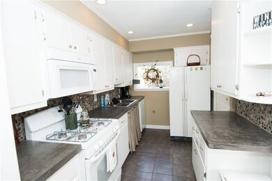 The kitchen has been updated with concrete counter