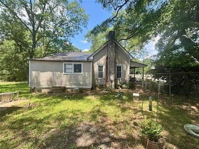 Back of house featuring a metal roof