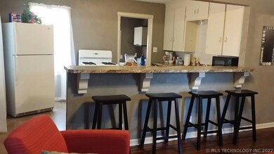Kitchen with a bar.