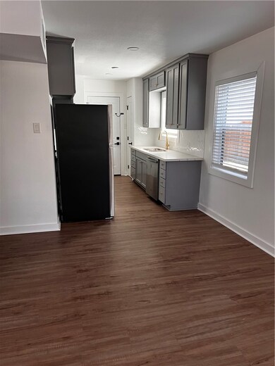 Kitchen featuring gray cabinets, light countertops