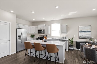 Open concept design with large pantry. Actual home is under construction. Colors, materials, and features may vary. See site agent for details.