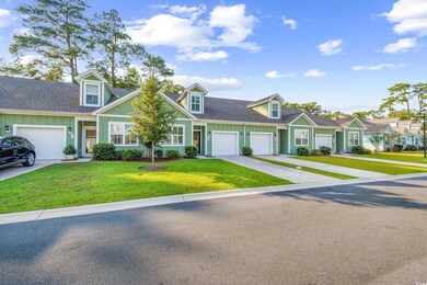 Cape cod-style house with a garage and a front law