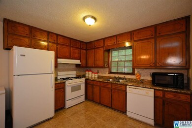 kitchen has been updated with new marble tile floo